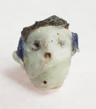Glass bead in the shape of a head