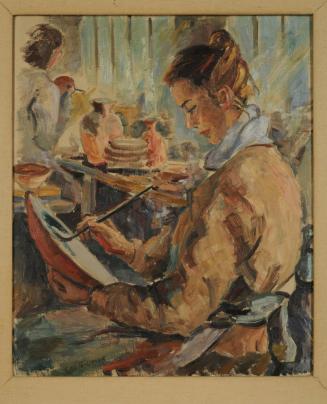 Woman painting pottery