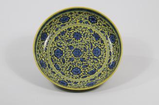 Saucer plate with flowers on yellow field