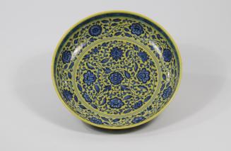 Saucer plate with flowers on yellow field